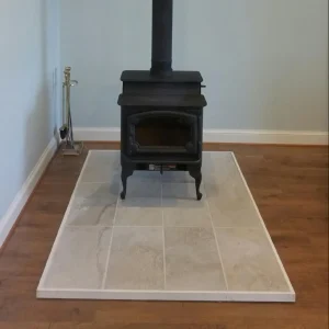 Freestanding wood stove professionally installed in Virginia Beach, VA with double-wall vent pipe, non-combustible hearth pad, and proper clearance from walls.
