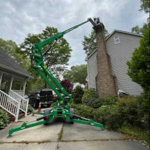 Major masonry chimney repair Chesapeake VA using heavy machinery to reach the top.