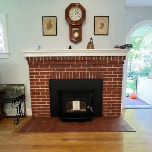Completed insert installation in Norfolk, VA showing a clean firebox, sealed flue liner, and proper insulation wrap.