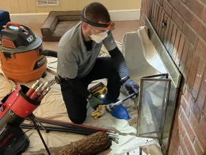 Professional CSIA Certified Chimney Sweep performing rotary chimney cleaning in Virginia Beach.