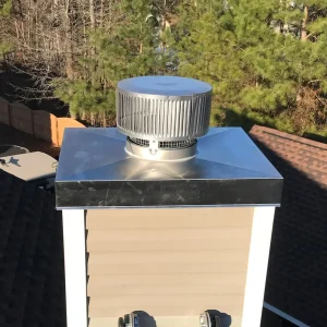 New stainless steel chase cover with cross breaks and drip edge. New prefab chimney cap for the new prefab fireplace installed inside.