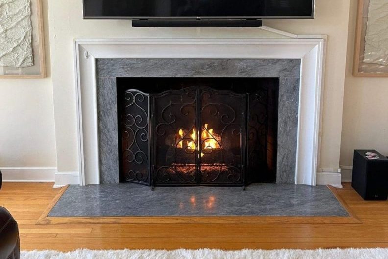 Restored gas fireplace with new gas logs and clean, professionally serviced firebox after expert gas fireplace repair by Premier Chimney and Roofing.