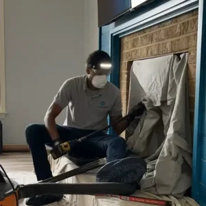 CSIA Certified Chimney Sweep using rotary-powered equipment for chimney cleaning in Chesapeake, VA.