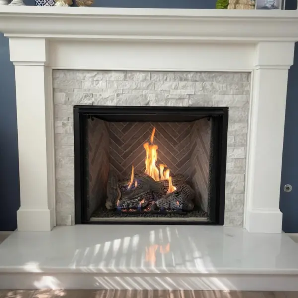 Custom ventless gas log installation with stone surround and white mantel